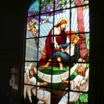 Stained glass window depicting Christ bringing hope to the leprosy affected