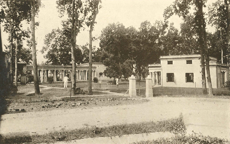 A view from the dressing stations, showing corner of the old hospital (left), covered way to the men’s hospital and the end of the ‘out-patients’ hospital.